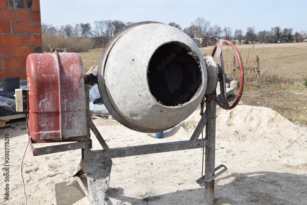 concrete mixer with cement and sand on the construction site concrete mixer with cement and sand on the construction site