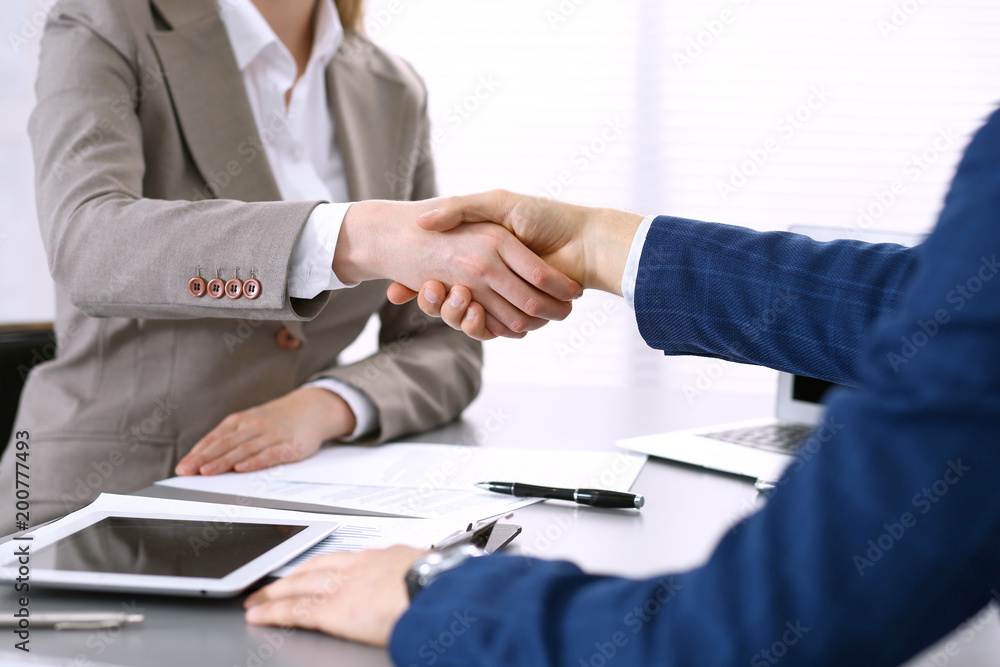 Business people shaking hands, finishing up a meeting. Papers signing, agreement and lawyer consulting concept Business people shaking hands, finishing up a meeting. Papers signing, agreement and lawyer consulting concept