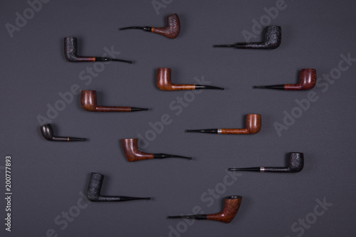 Smoking pipes on dark background.