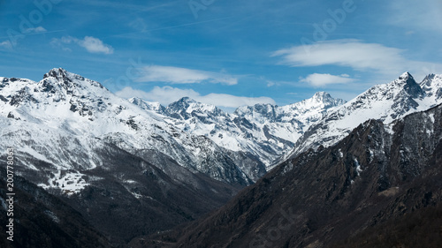 Panoramic view of high mountain peaks and snowcapped ridges at high altitude in the Alps