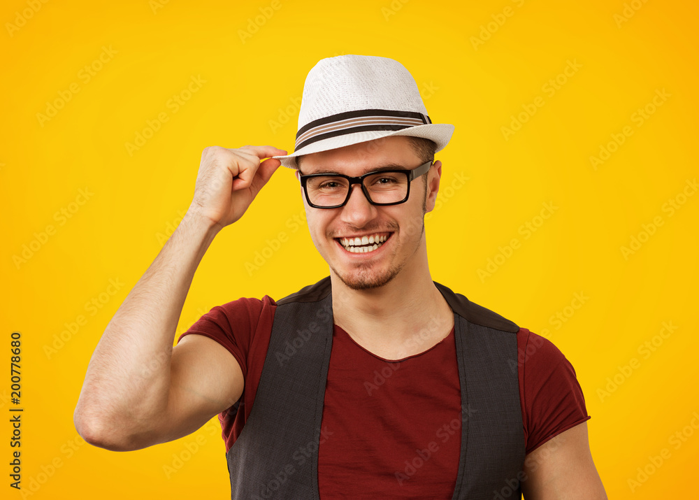 Cheerful hipster in hat smiling at camera