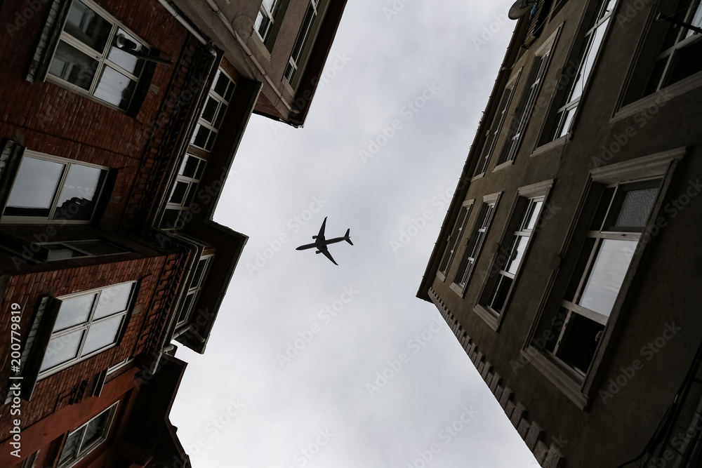 Airplane passing over Fener District in Istanbul, Turkey