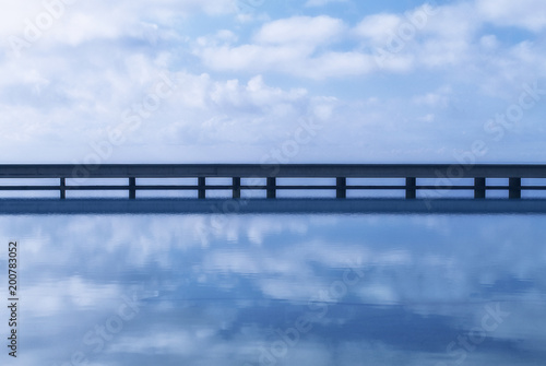 Bridge and sea water reflection photo