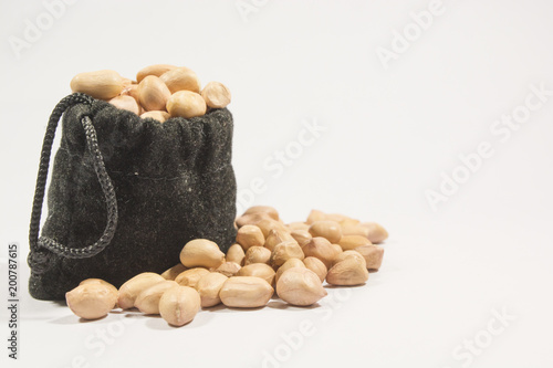Peanuts in burlap bag isolated on white background