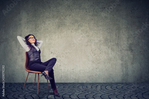 Relaxed businesswoman resting on chair