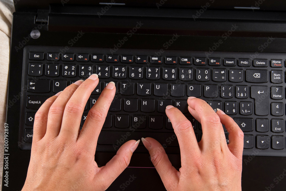 Woman sitting on bed and writes on a computer. Woman sitting on bed and writes on a computer.