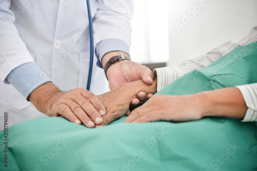 Doctor is reassuring his male patient.
