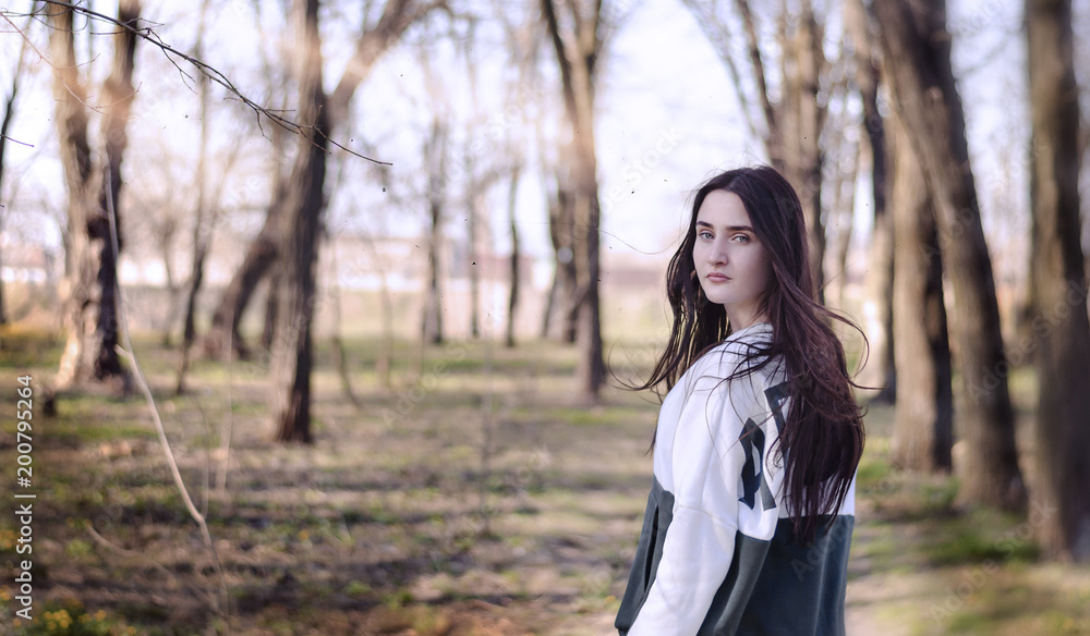 a beautiful girl on a background of a spring park a beautiful girl on a background of a spring park