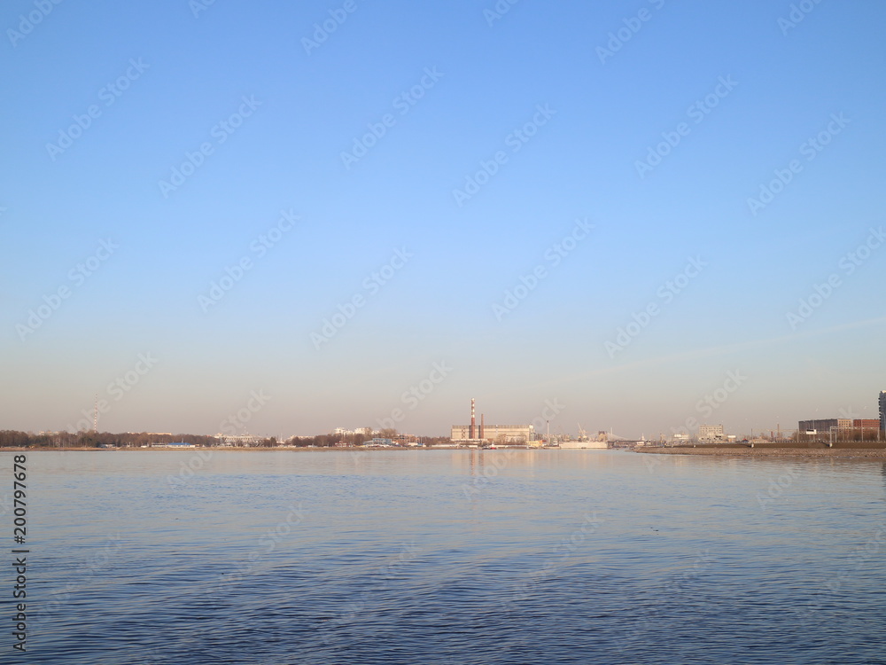 a wide river in the city in the spring evening