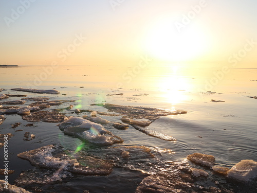 Spring in the city on the shore of the bay drift ice on the river