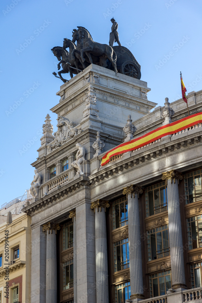 Building with Sculpture of a chariot at Alcala street in city of Madrid, Spain