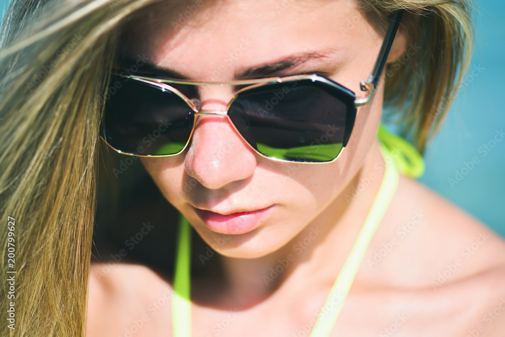 Closeup fashion beautiful woman portrait wearing sunglasses. Portrait of happy teenage girl in sunglasses. Summer lady Closeup fashion beautiful woman portrait wearing sunglasses. Portrait of happy teenage girl in sunglasses. Summer lady
