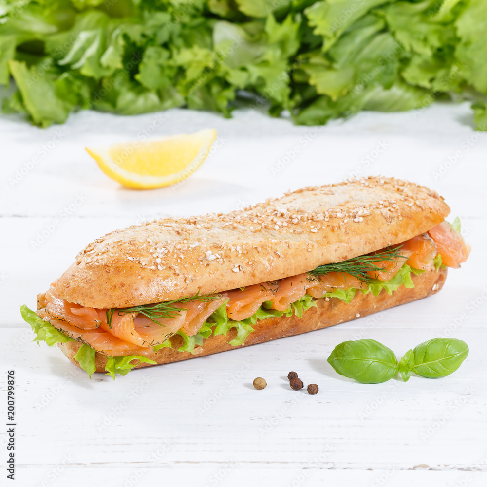 Sub sandwich whole grains baguette with smoked salmon fish square on wooden board Sub sandwich whole grains baguette with smoked salmon fish square on wooden board