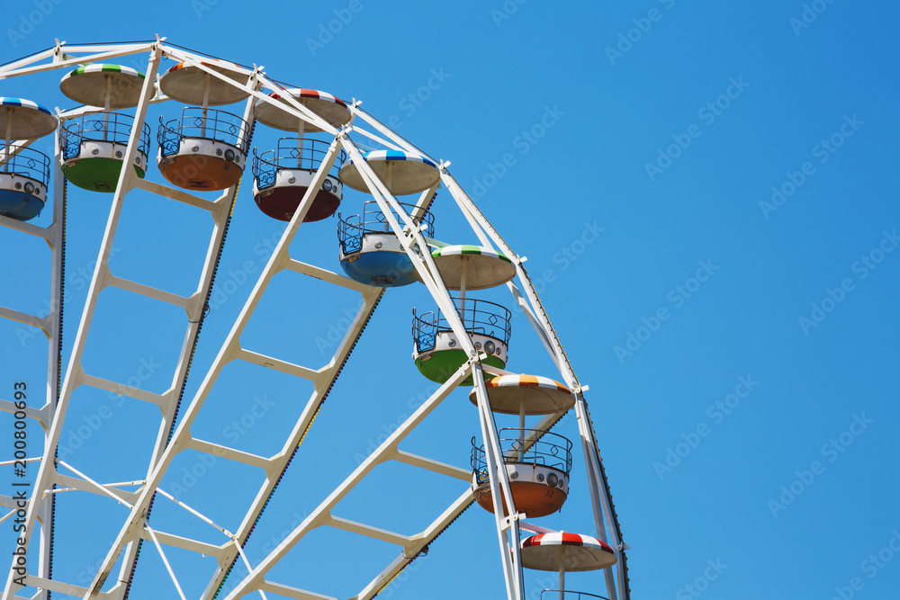 Colorful ferris wheel on blue sky background in Luna Park.