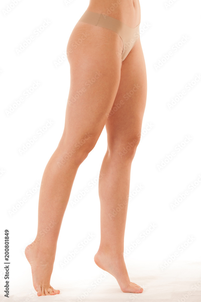 Beautiful long slim and elegant woman legs isolated over white background Beautiful long slim and elegant woman legs isolated over white background