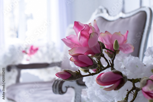 Interior of the living room in Victorian style with a vintage sofa and a vase with flowers