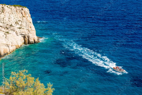 View of boat on blue sea near Skinari cape on Zakynthos island. Greece.