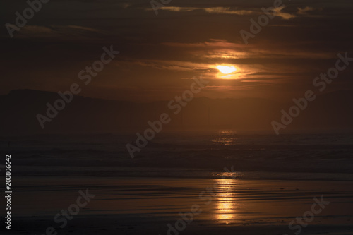 silhouettes on the beach at sunset