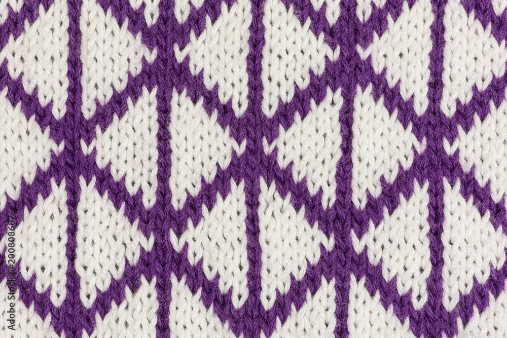 background of knitted fabric in white and purple with triangles
