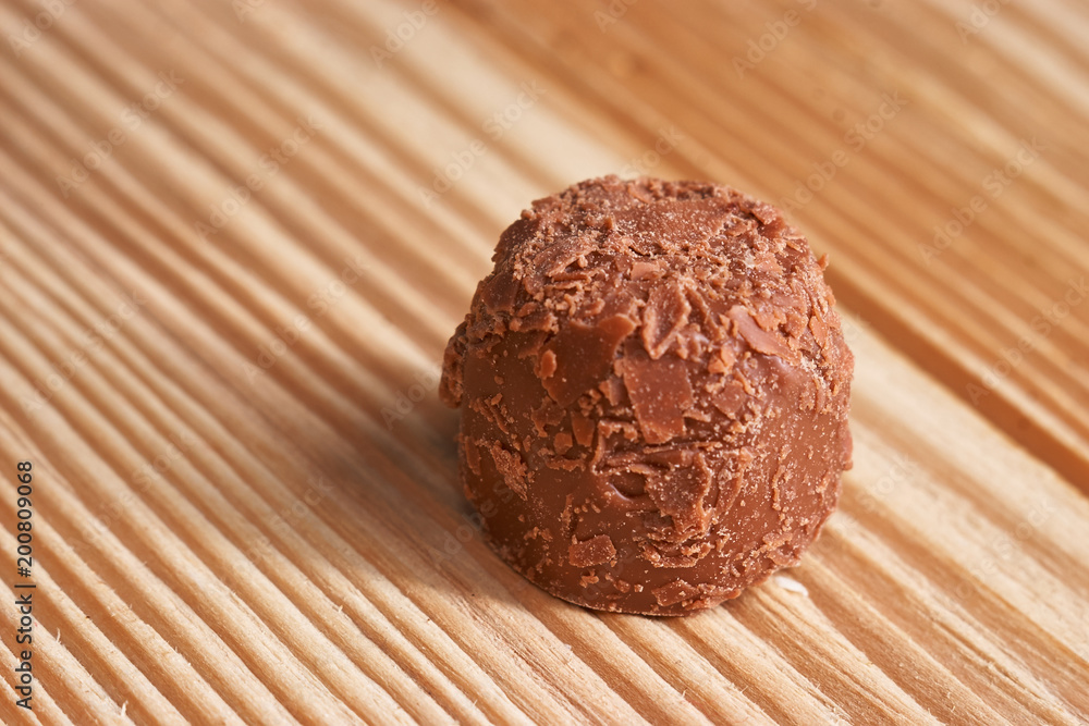 Macro. Chocolate candies on a light wooden background Macro. Chocolate candies on a light wooden background