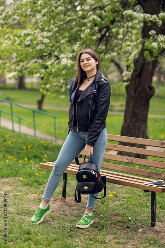 Glamorous young caucasian woman in black leather jacket