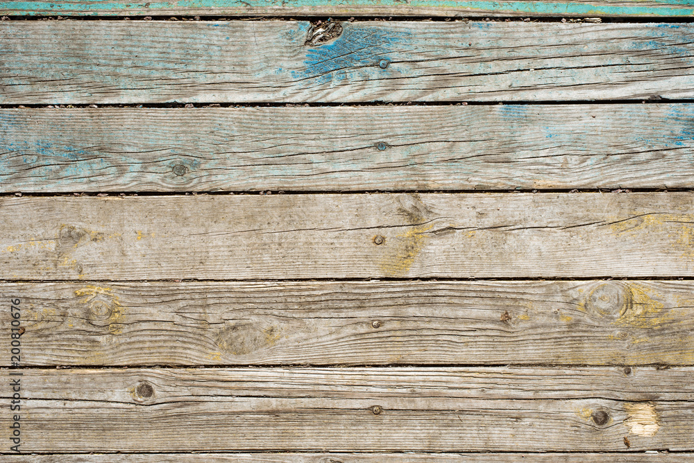 Old boards with the remains of green paint - rustic wooden background Old boards with the remains of green paint - rustic wooden background