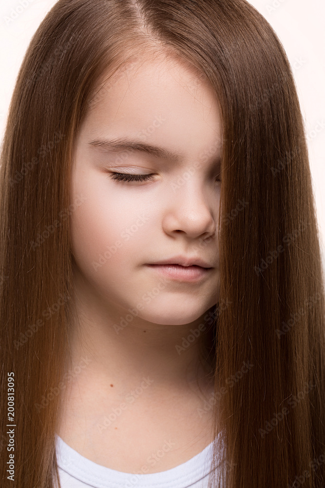 Beautiful little girl caucasian with long dark hair happy smiling on studio. Isolated white background Beautiful little girl caucasian with long dark hair happy smiling on studio. Isolated white background