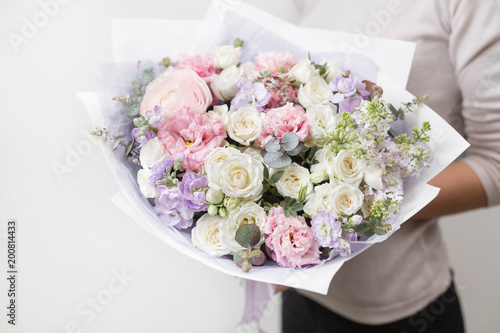 bouquet of beautiful flowers in women's hands. Floristry concept. Spring colors. the work of the florist at a flower shop. Horizontal photo © malkovkosta