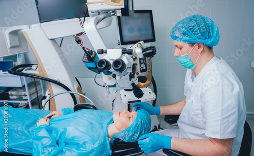 Eye surgery. A patient and surgeon in the operating room during ophthalmic surgery. Vision correction
