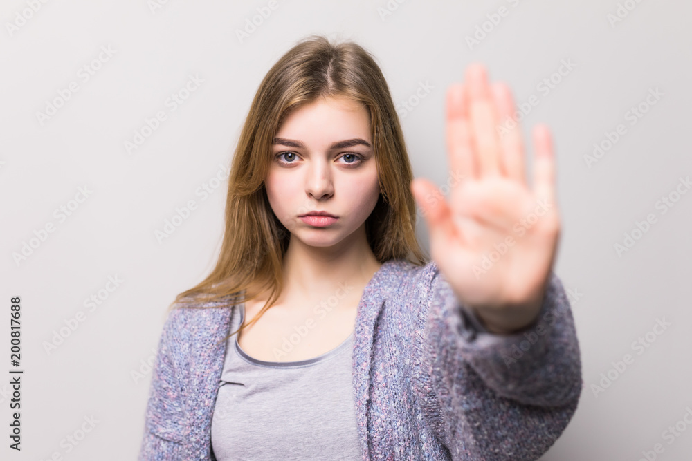 Confident woman making stop gesture sing with hand isolated on white background Confident woman making stop gesture sing with hand isolated on white background