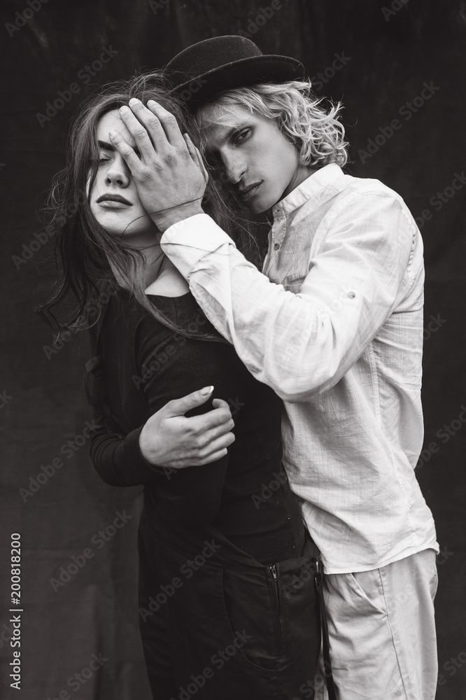 A beautiful couple on a black background is full of emotions A beautiful couple on a black background is full of emotions