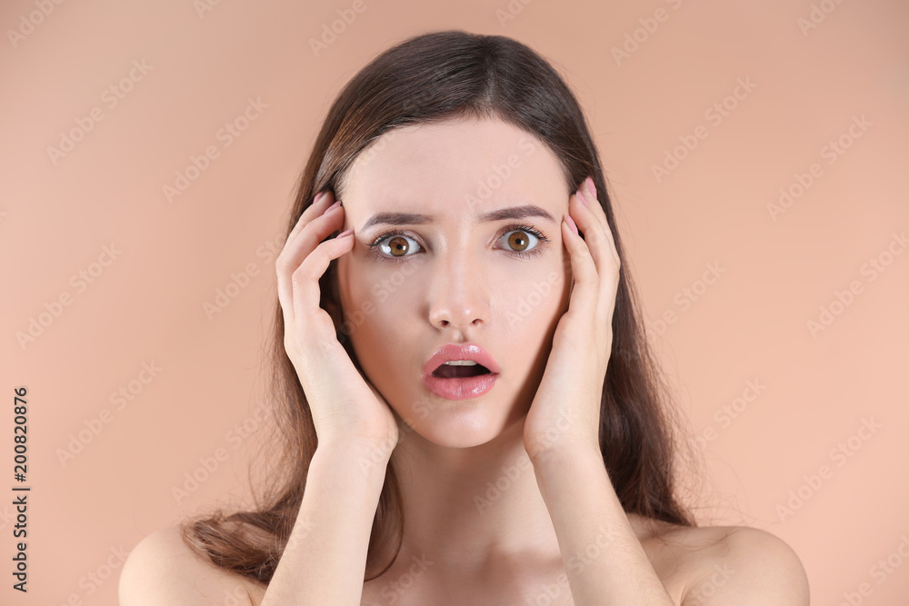 Teenage girl with acne problem against color background Teenage girl with acne problem against color background