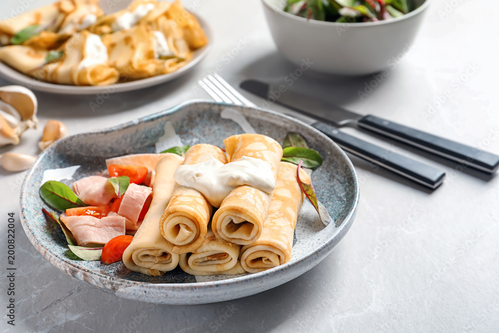 Thin pancakes with garnish on plate Thin pancakes with garnish on plate