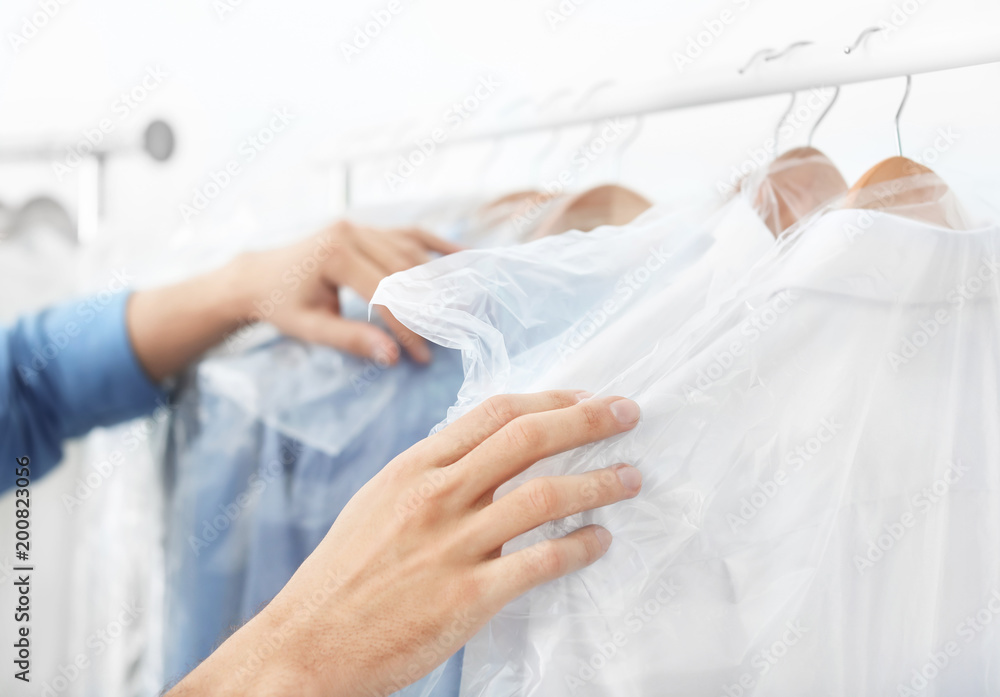 Employee working at dry-cleaner's Employee working at dry-cleaner's