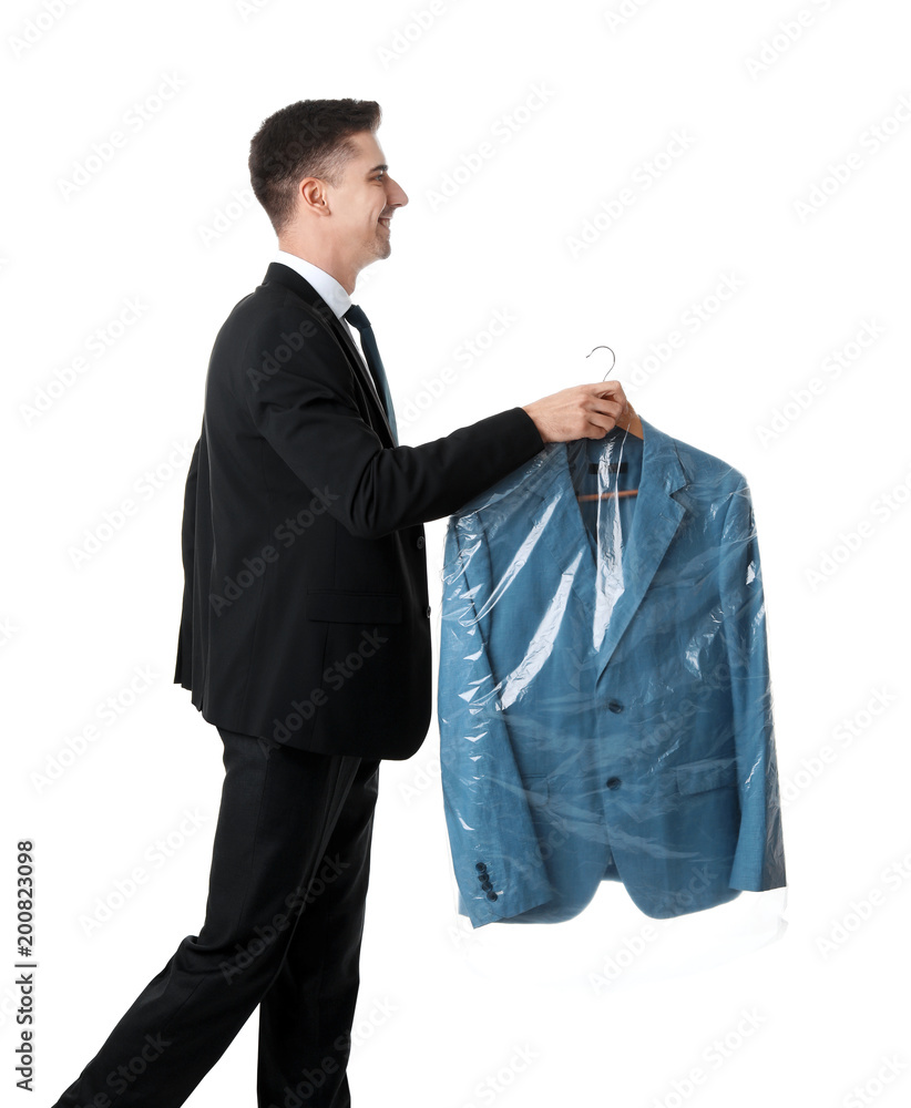 Young businessman holding hanger with jacket in plastic bag on white background. Dry-cleaning service Young businessman holding hanger with jacket in plastic bag on white background. Dry-cleaning service
