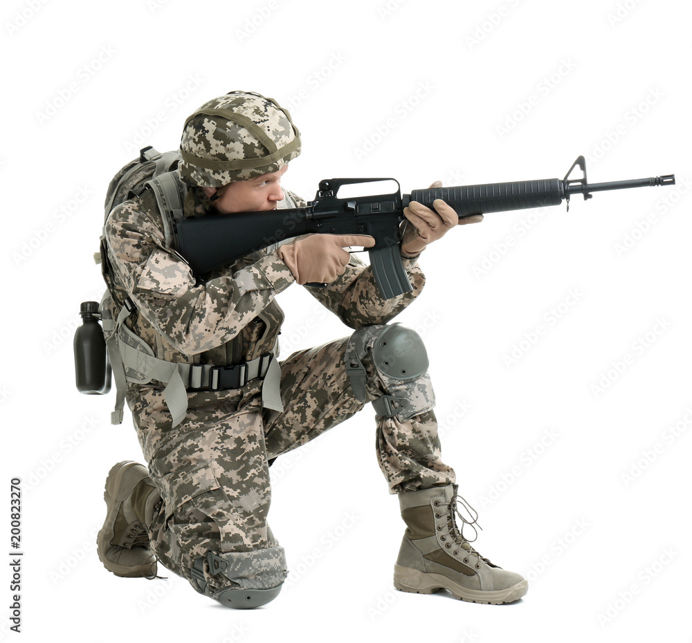 Fototapeta premium Male soldier with machine gun on white background. Military service