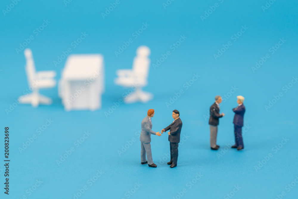 business miniature people shaking hand in office business miniature people shaking hand in office