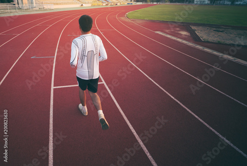 Athlete runs around the stadium in the morning