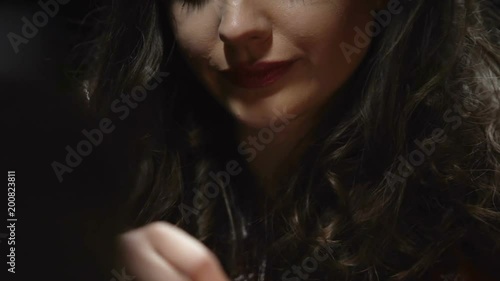 Handcuffed young woman talking carelessly to investigator at police station