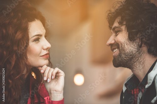 Cheerful loving couple is flirting and smiling indoors. Romantic date concept photo