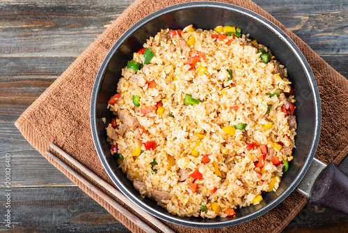 Fried rice with vegetables and pork in a pan, Thai cuisine, top view
