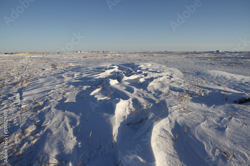 Winter landscape with Sastrugi, wind carved ridges in the snow, near Arviat Nunavut Canada