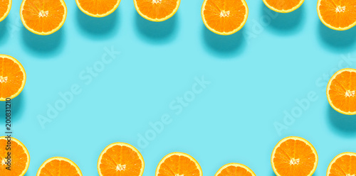 Fresh orange halves on a blue background