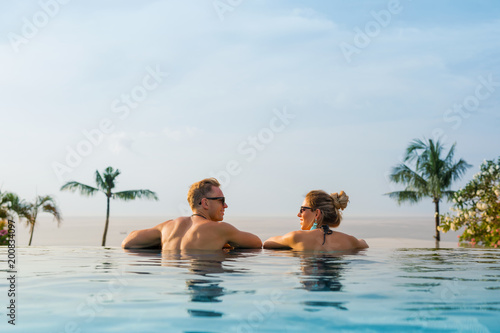 Happy couple in infinity pool