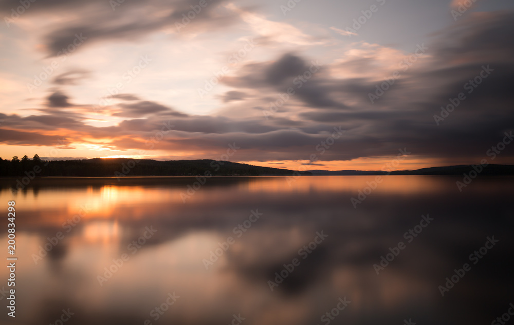 Beautiful sunset over a swedish natural lake photographed with long exposure