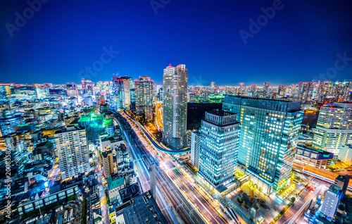 Asia business concept for real estate and corporate construction - panoramic urban city skyline aerial view under twilight sky and neon night with highway junction in hamamatsucho, tokyo, Japan © voyata