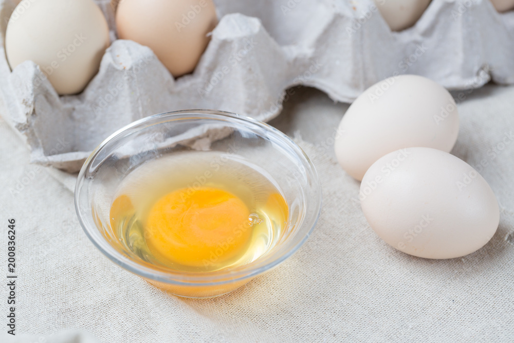 Fresh farm eggs. Egg yolk in glass bowl. Fresh farm eggs. Egg yolk in glass bowl.