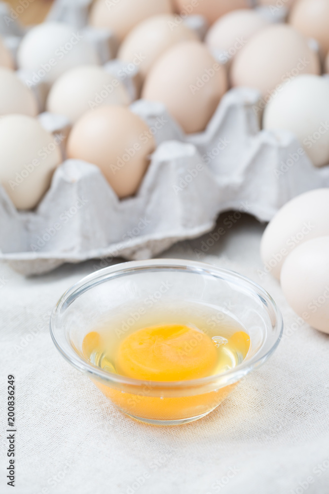 Fresh farm eggs. Egg yolk in glass bowl. Fresh farm eggs. Egg yolk in glass bowl.