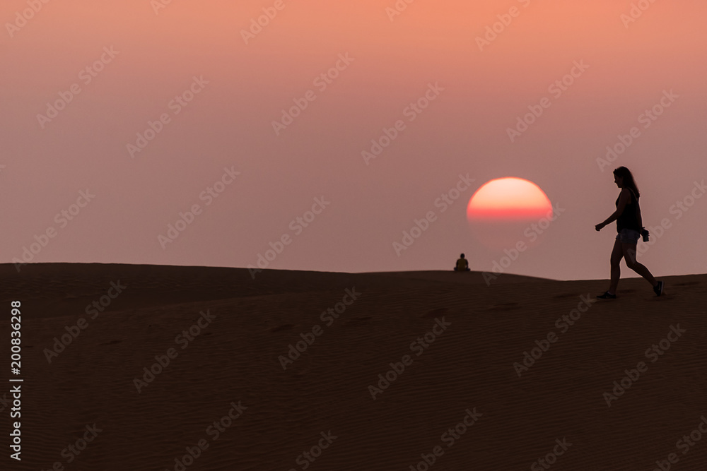 people walking in Mui Ne sand dunes at sunset in Vietnam