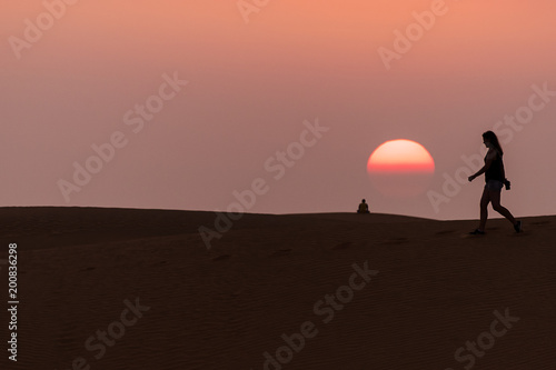 people walking in Mui Ne sand dunes at sunset in Vietnam